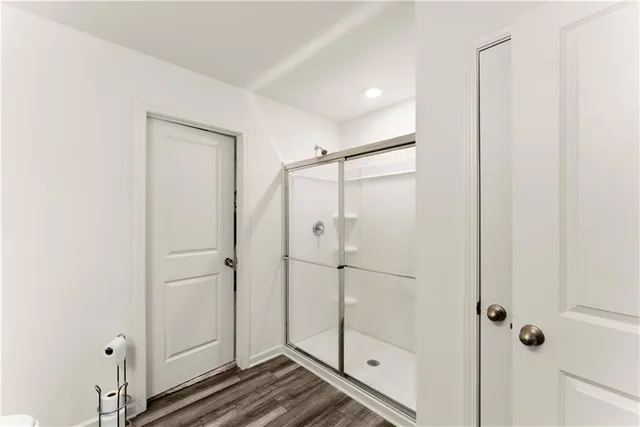 a bathroom with a glass shower door