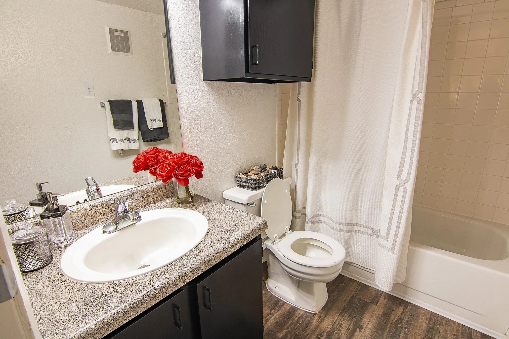 15100 Golden Eagle Drive, Unit 1008 Humble, TX 77396 - Photo 12 of 22 a bathroom with a granite countertop sink a toilet and a mirror