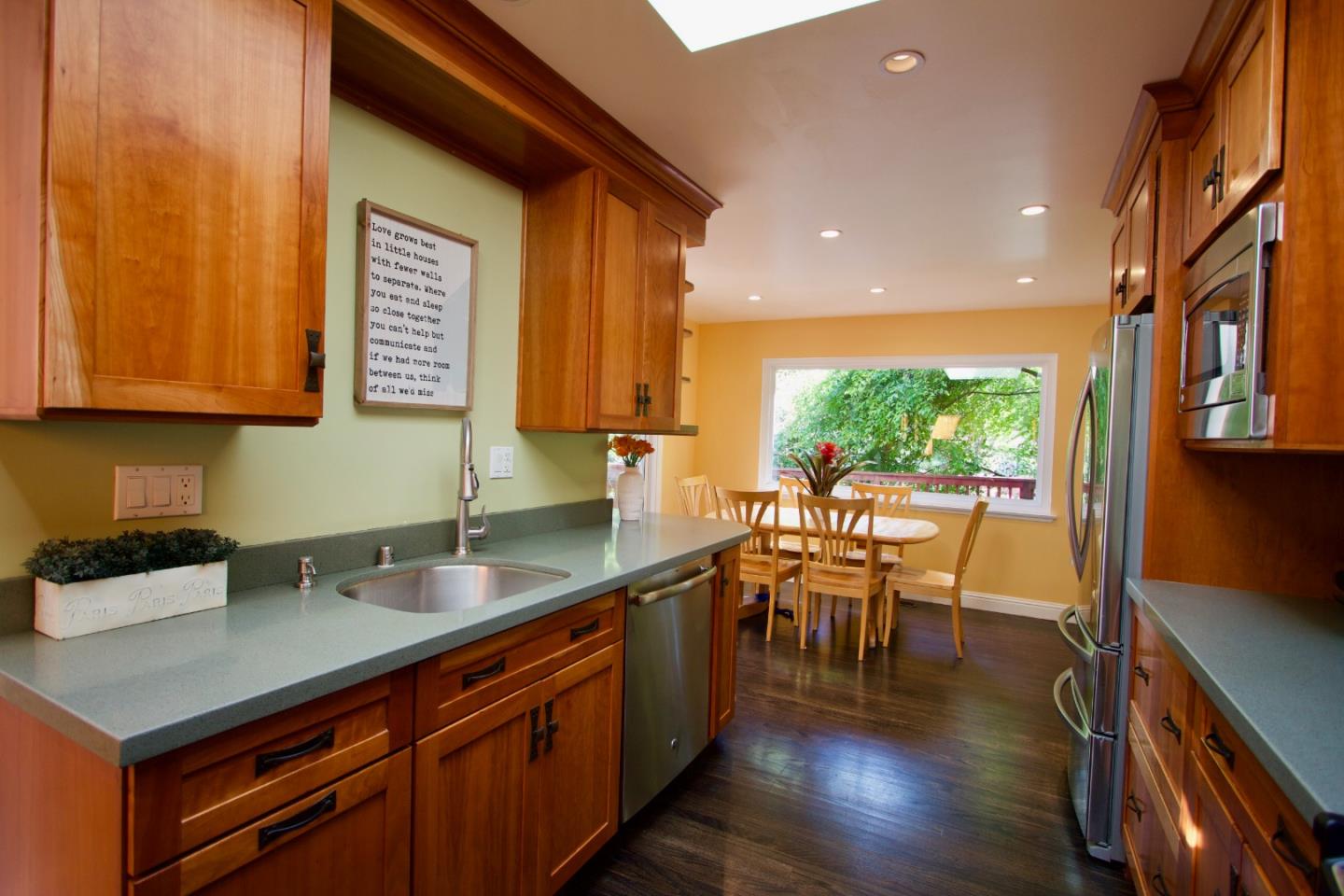 211 Modoc Place Pacifica, CA 94044 - Photo 5 of 25 a kitchen with stainless steel appliances granite countertop sink stove top oven and cabinets