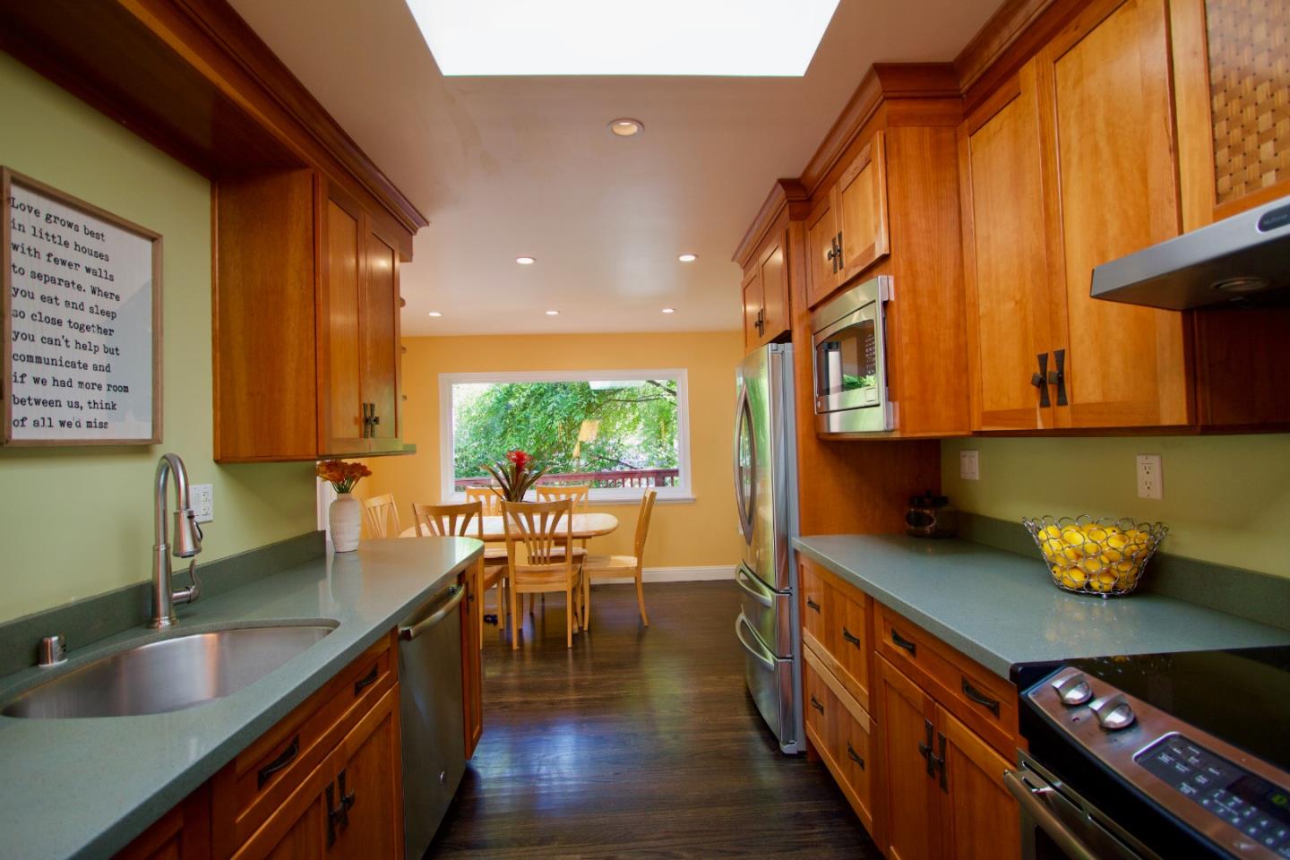 211 Modoc Place Pacifica, CA 94044 - Photo 6 of 25 a kitchen with stainless steel appliances granite countertop sink stove and cabinets