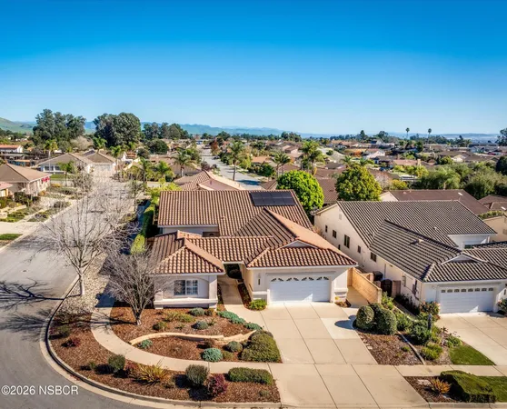 an aerial view of a house with a swimming pool