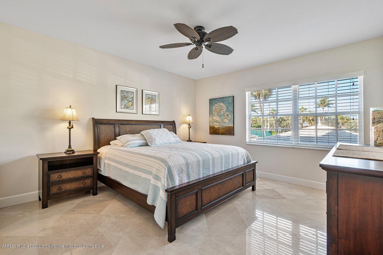 5900 Old Ocean Boulevard, Unit B1 Ocean Ridge, FL 33435 - Photo 13 of 26 a spacious bedroom with a bed and a large window