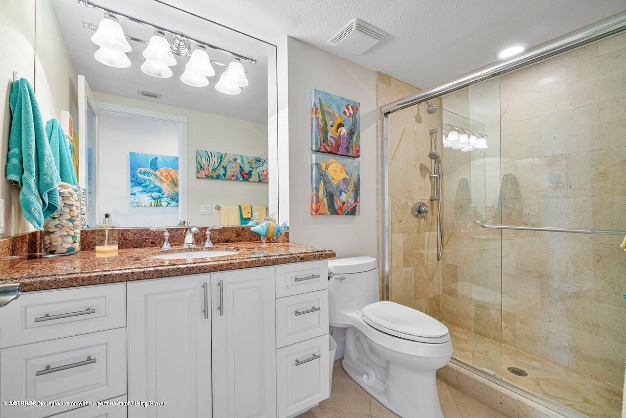 5900 Old Ocean Boulevard, Unit B1 Ocean Ridge, FL 33435 - Photo 16 of 26 a bathroom with a granite countertop sink mirror vanity and toilet