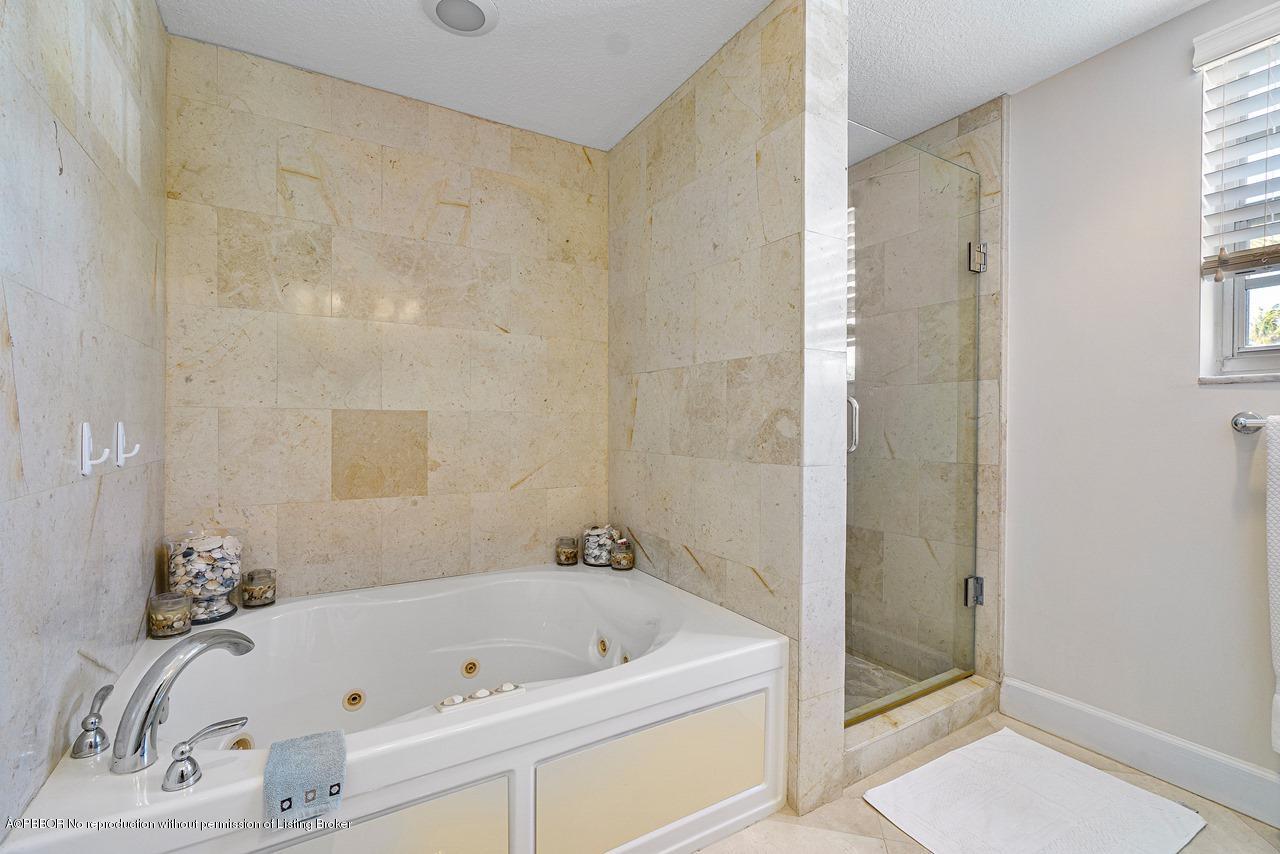 5900 Old Ocean Boulevard, Unit B1 Ocean Ridge, FL 33435 - Photo 18 of 26 a bathroom with a tub a sink and a shower