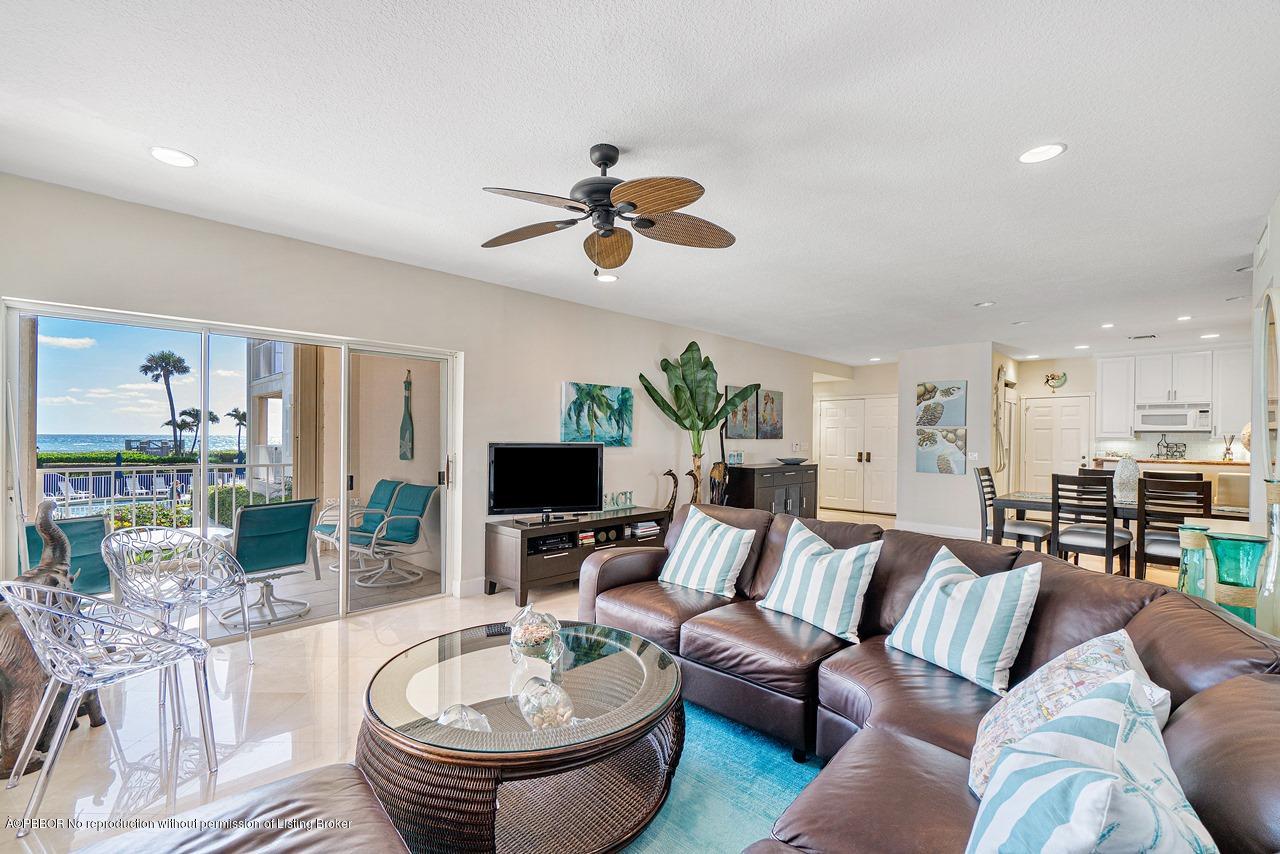 5900 Old Ocean Boulevard, Unit B1 Ocean Ridge, FL 33435 - Photo 7 of 26 a living room with furniture a chandelier and a flat screen tv