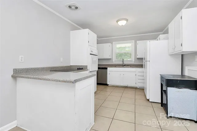a kitchen with a sink a stove and cabinets