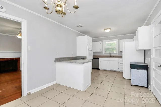 a kitchen with a white cabinets and white appliances