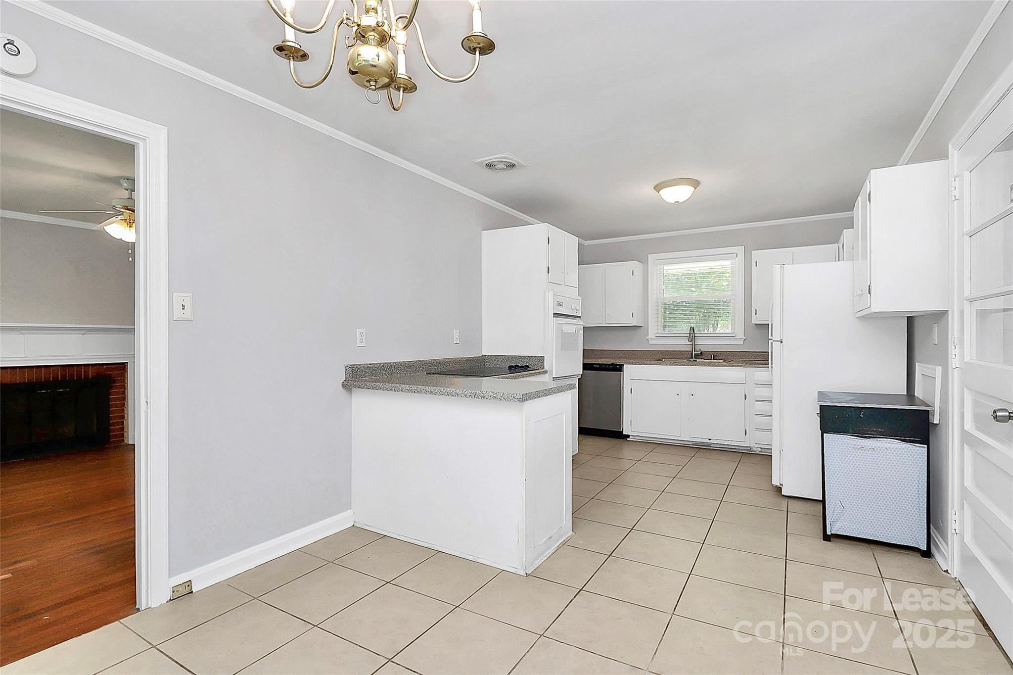 228 Seneca Place Charlotte, NC 28210 - Photo 14 of 34 a kitchen with a white cabinets and white appliances