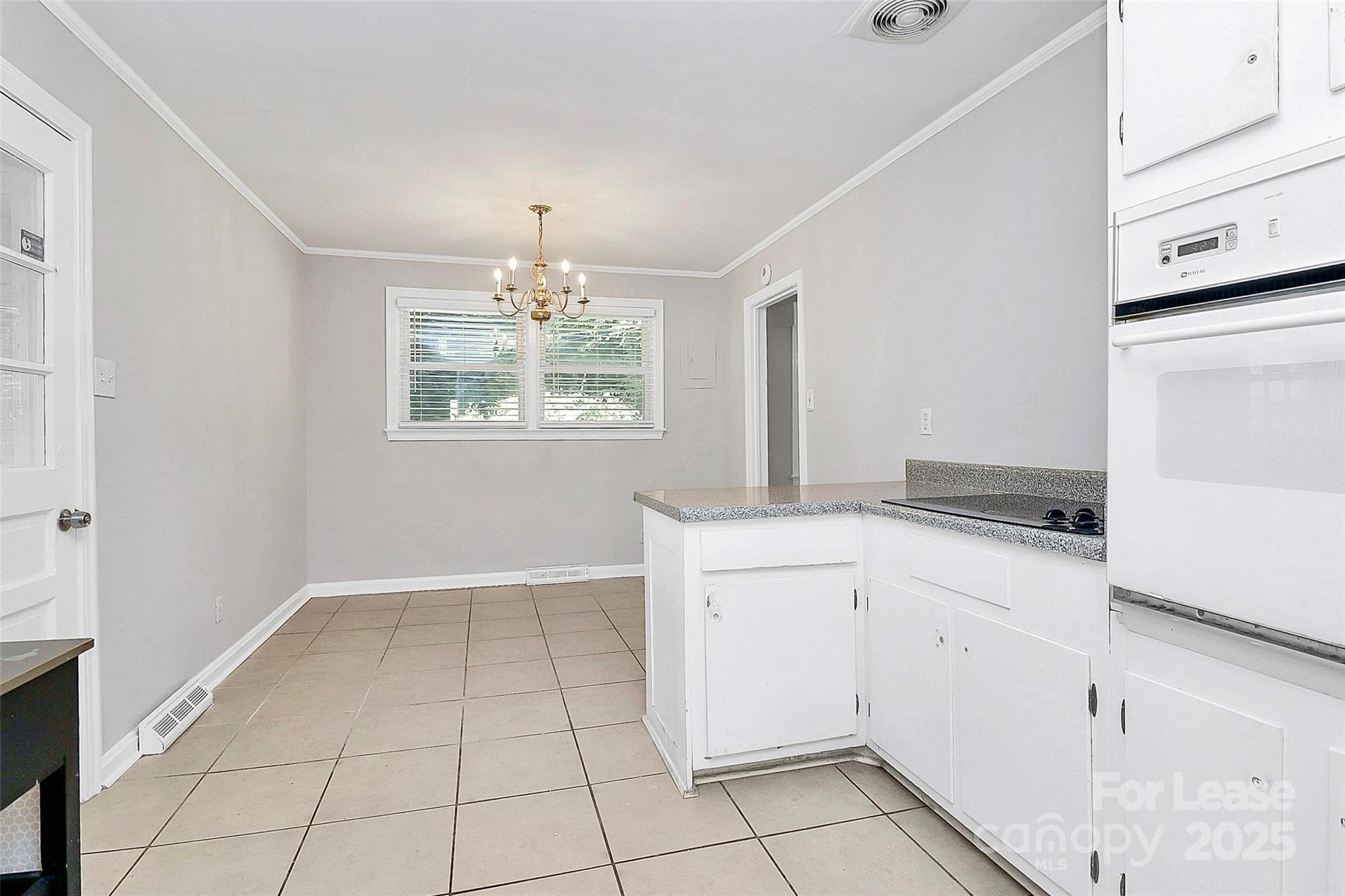 228 Seneca Place Charlotte, NC 28210 - Photo 16 of 34 a kitchen with granite countertop white cabinets and white appliances