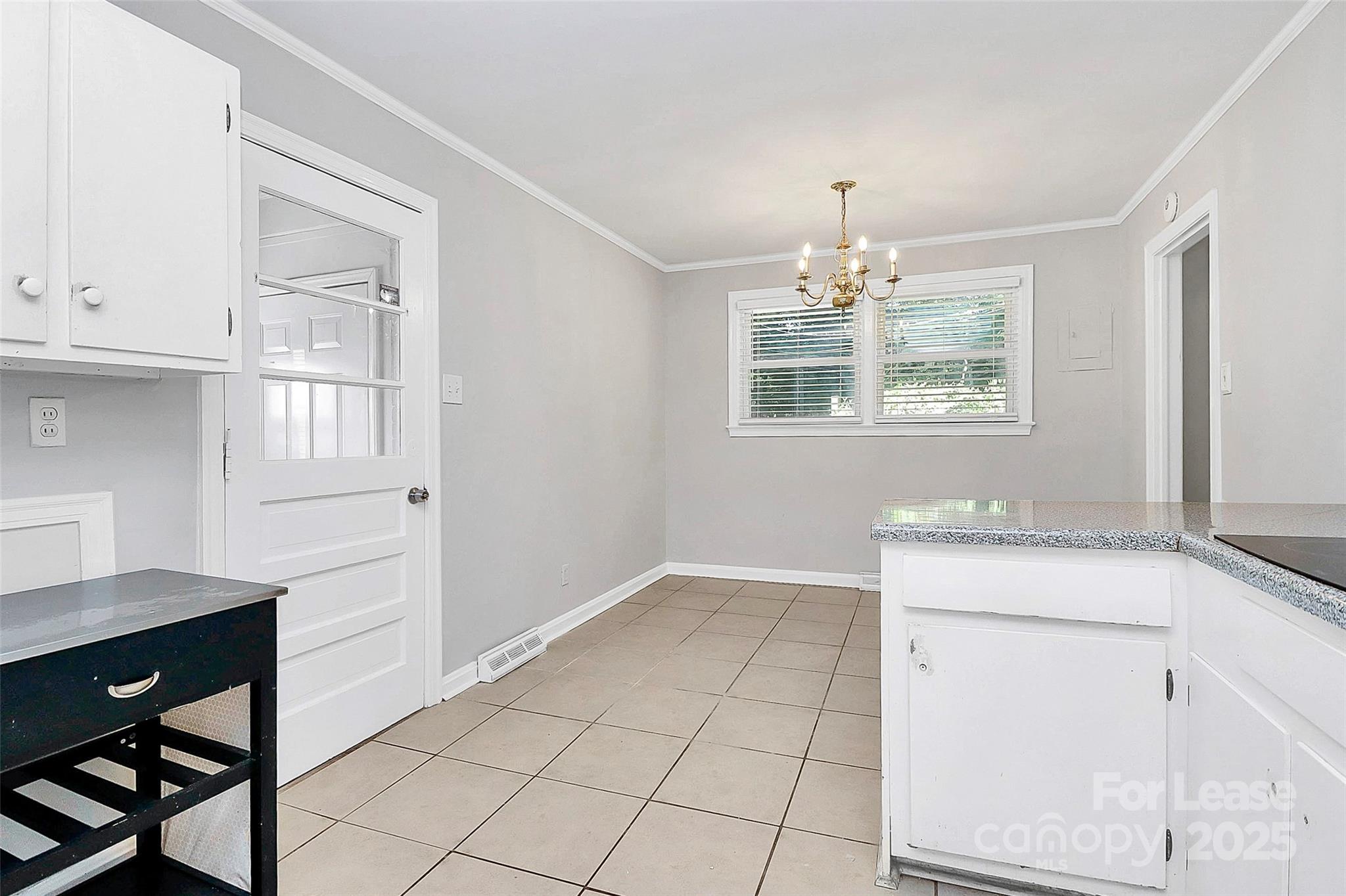 228 Seneca Place Charlotte, NC 28210 - Photo 18 of 34 a workspace with chandelier