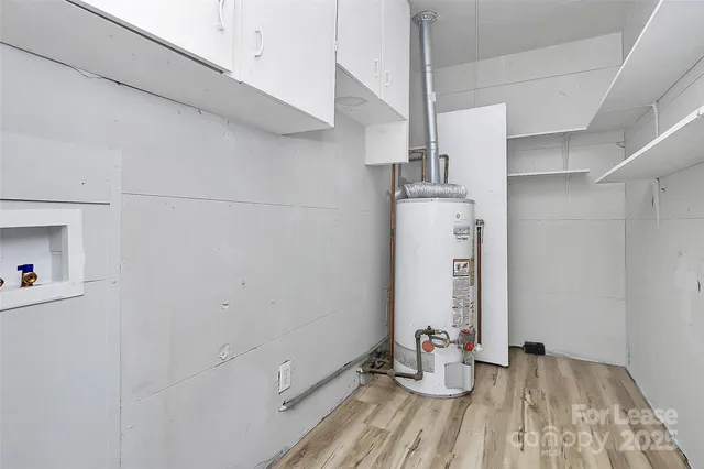 a view of room with window and wooden floor