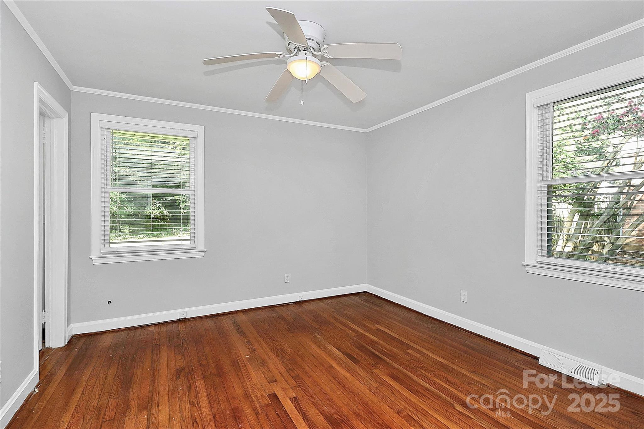 228 Seneca Place Charlotte, NC 28210 - Photo 20 of 34 a view of an empty room with wooden floor and a window