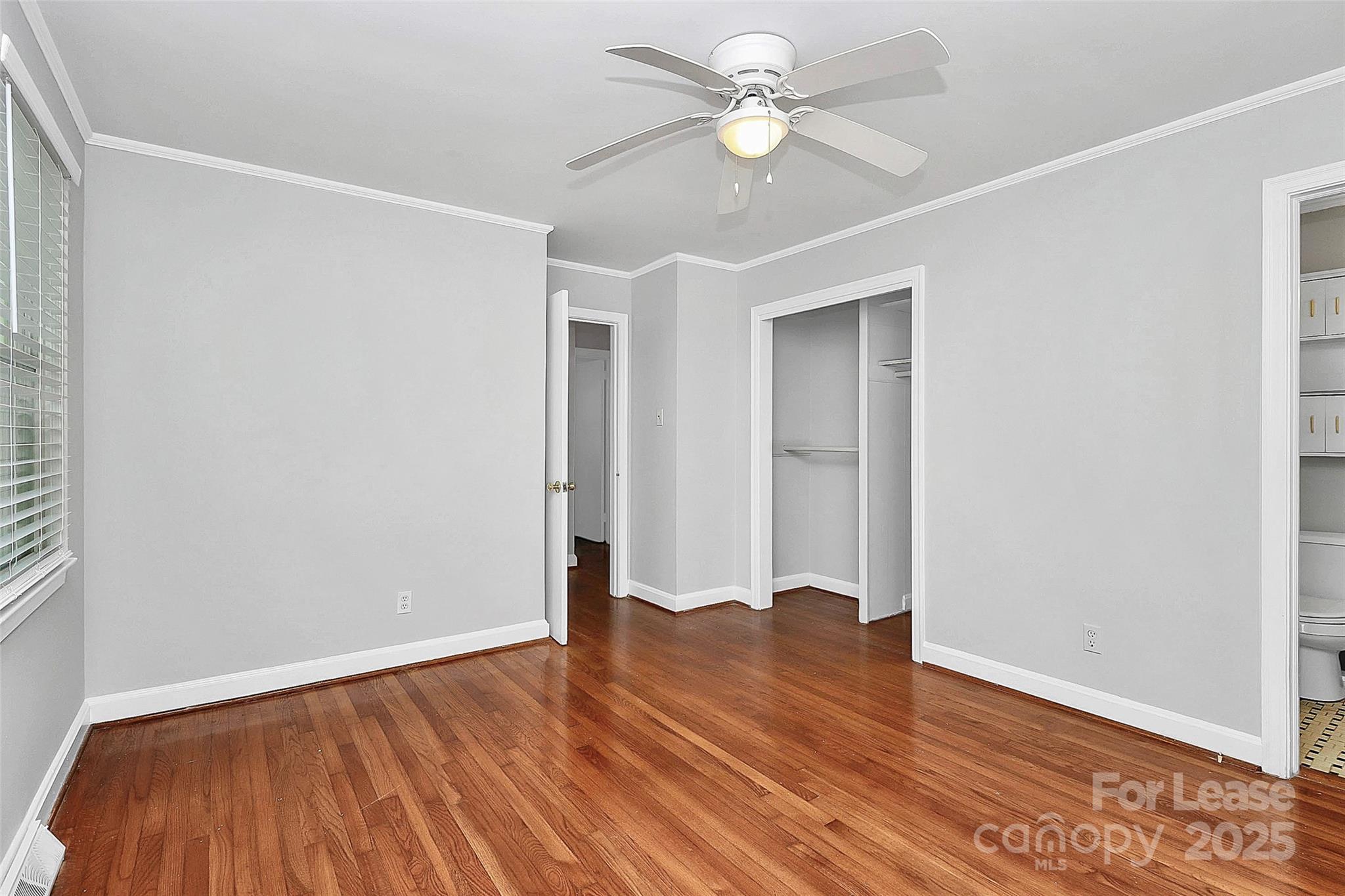 228 Seneca Place Charlotte, NC 28210 - Photo 21 of 34 an empty room with wooden floor fan and windows