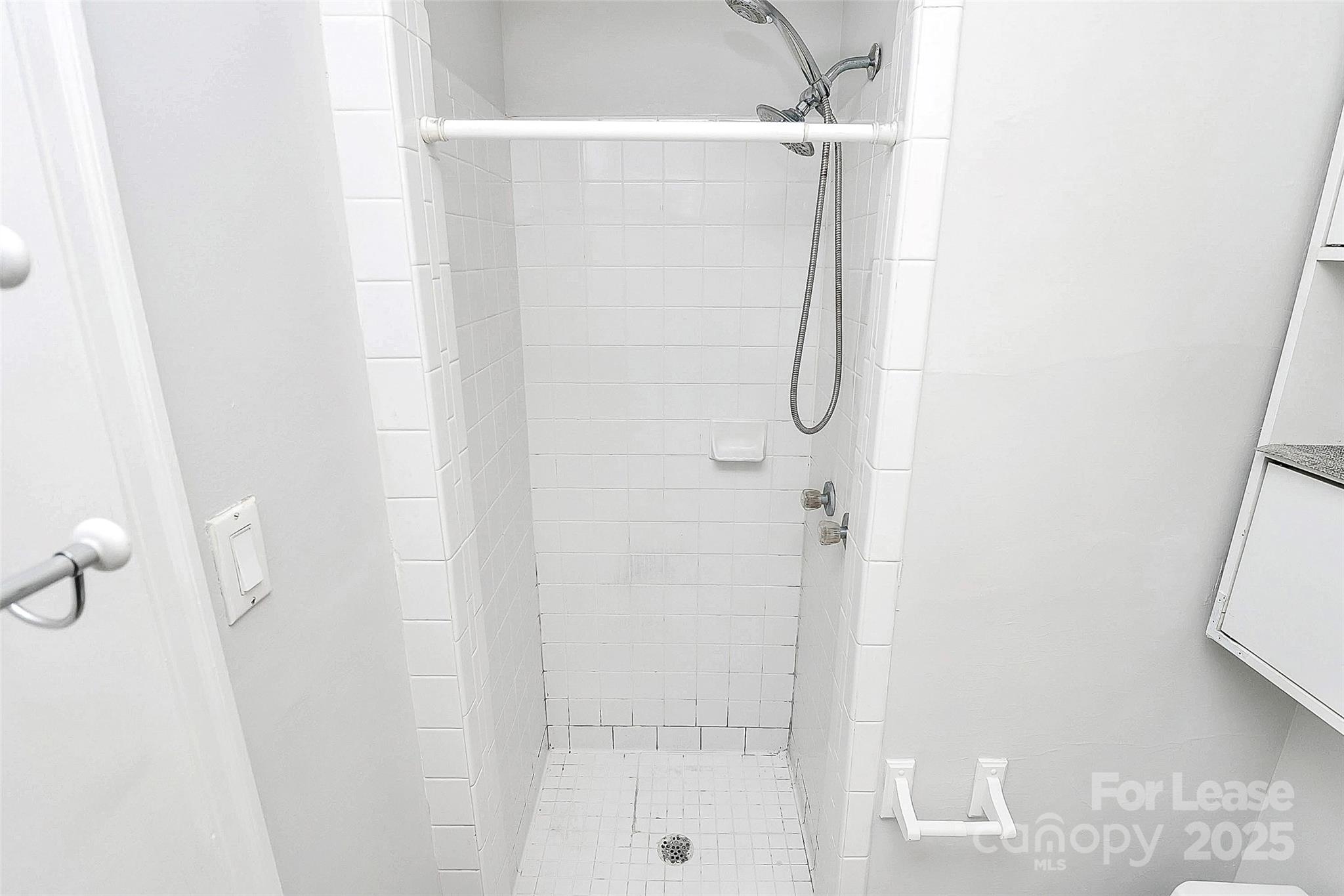 228 Seneca Place Charlotte, NC 28210 - Photo 23 of 34 a bathroom with a glass shower door