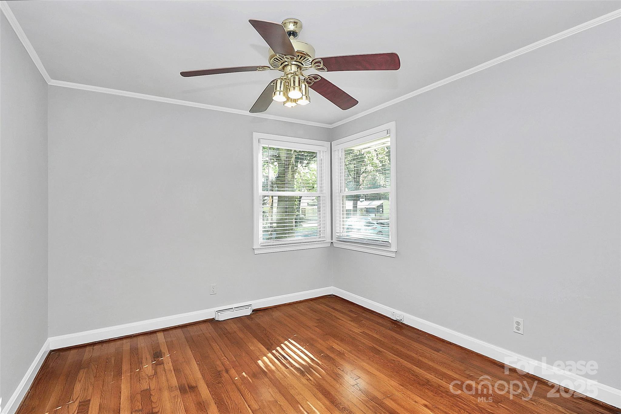 228 Seneca Place Charlotte, NC 28210 - Photo 24 of 34 an empty room with wooden floor fan and windows