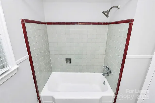 a bathroom with a shower and a sink