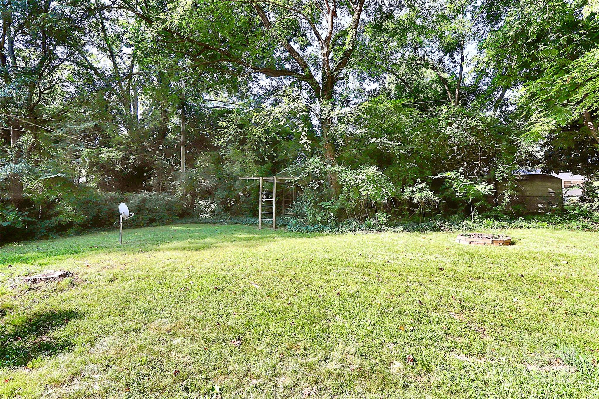 228 Seneca Place Charlotte, NC 28210 - Photo 34 of 34 a backyard of a house with lots of plants and large tree