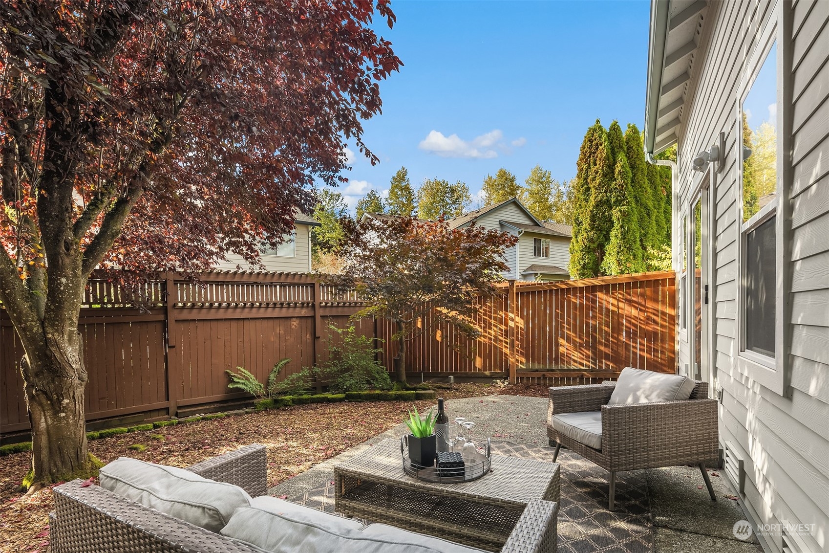 18710 20th Avenue Southeast Bothell, WA 98012 - Photo 38 of 40 a view of a patio with table and chairs and potted plants