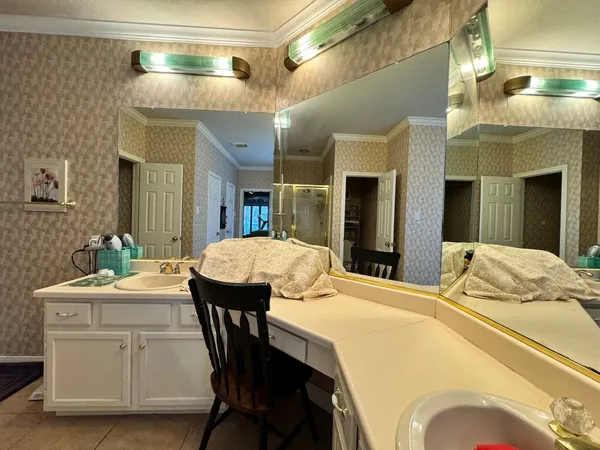 a bathroom with a granite countertop sink and mirror