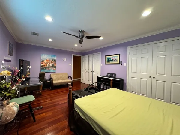 a bedroom with a bed and a dresser