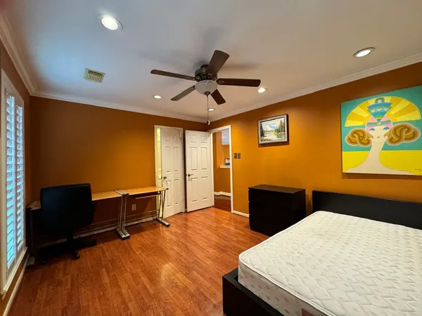 a bedroom with furniture and a ceiling fan