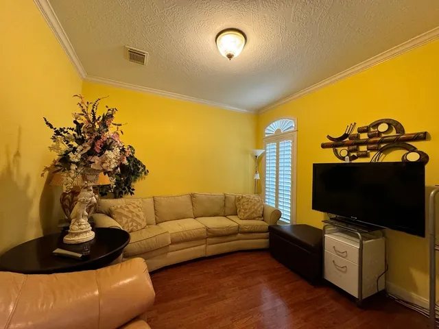 a bedroom with a bed lamps and wooden floor
