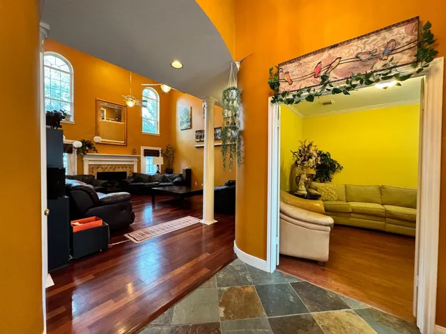 a living room with fireplace furniture and a wooden floor