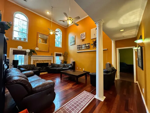 a living room with furniture and a floor to ceiling window