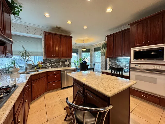 a kitchen with refrigerator and cabinets