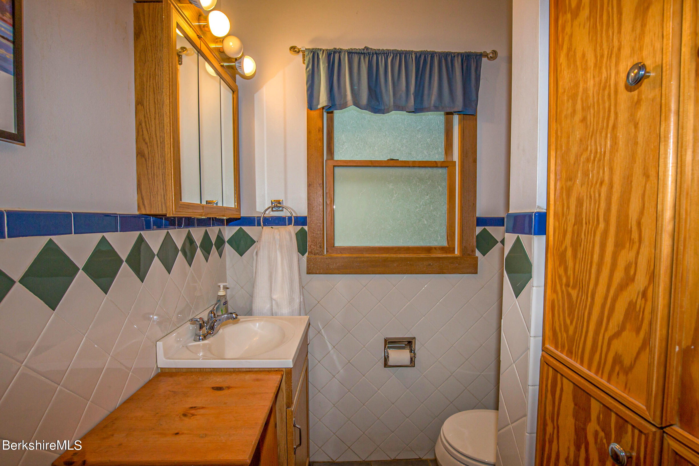 39 Lake Rd Extension Richmond, MA 01201 - Photo 27 of 47 a bathroom with a sink a toilet and shower curtain