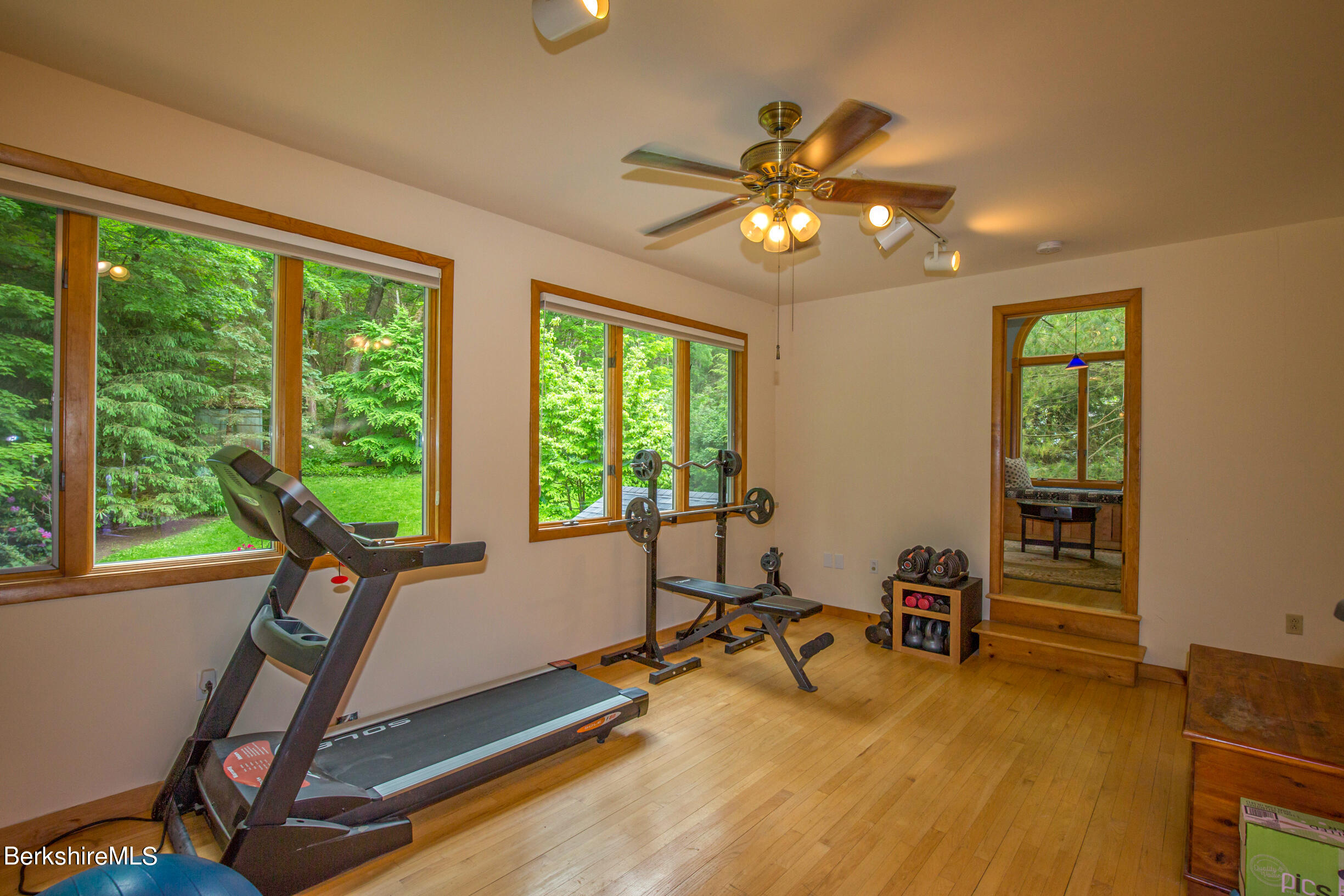 39 Lake Rd Extension Richmond, MA 01201 - Photo 32 of 47 a view of a room with gym equipment and a large window