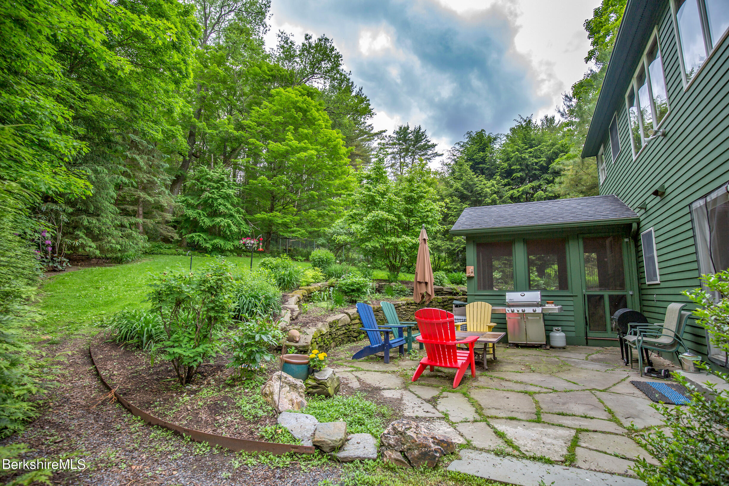 39 Lake Rd Extension Richmond, MA 01201 - Photo 42 of 47 a view of a chairs and fire pit in backyard of the house