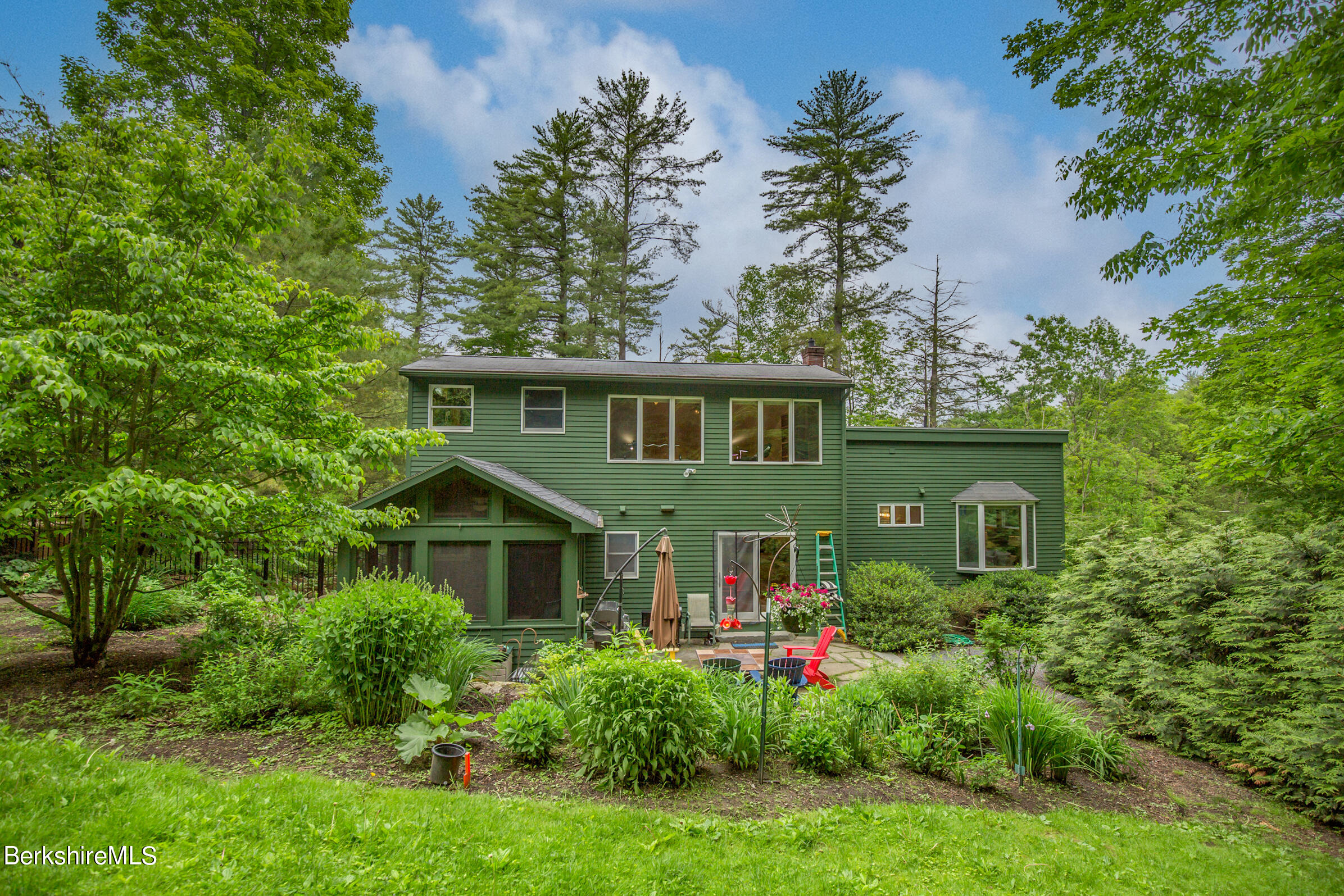 39 Lake Rd Extension Richmond, MA 01201 - Photo 43 of 47 a front view of a house with plants and garden
