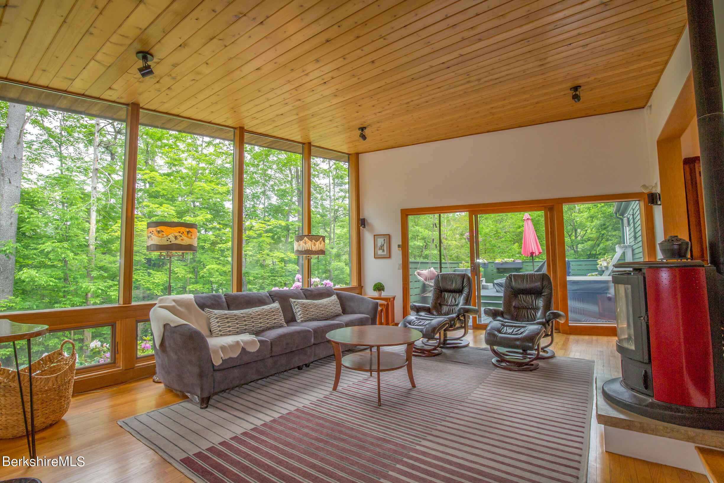 39 Lake Rd Extension Richmond, MA 01201 - Photo 6 of 47 a living room with furniture a fireplace and large windows