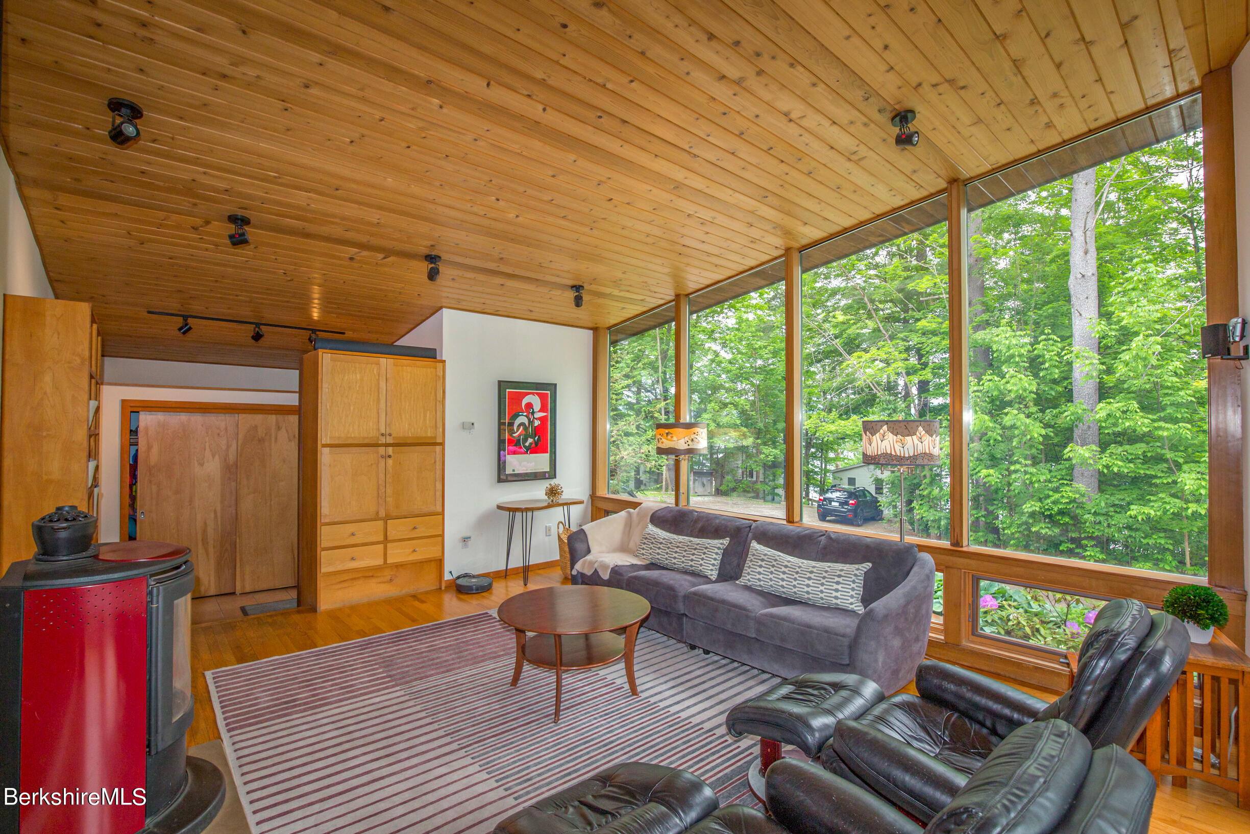 39 Lake Rd Extension Richmond, MA 01201 - Photo 10 of 47 a living room with furniture a flat screen tv and a table