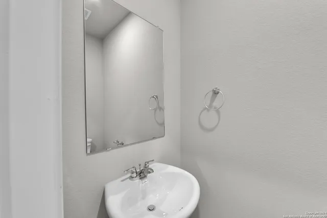 a bathroom with a sink and mirror