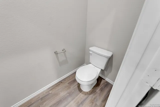 a white toilet sitting next to a shower