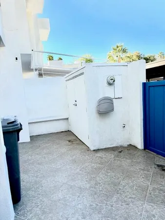 a view of a storage and utility room with wooden floor