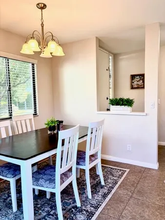 a view of a dining room with furniture and window