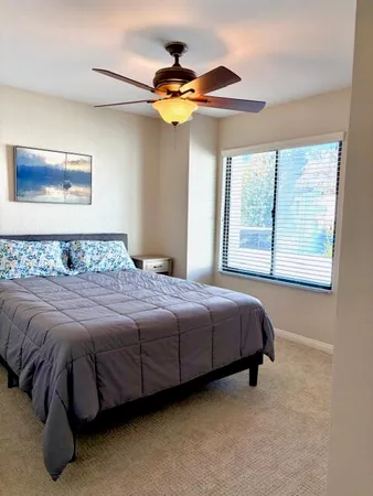 a bedroom with a bed and a window