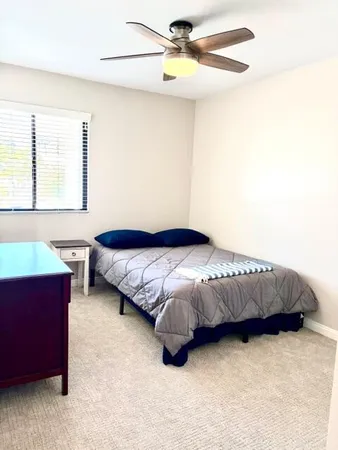 a bedroom with a bed dresser and a window