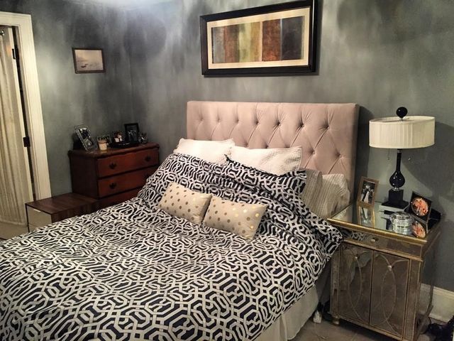 a living room with a couch wooden floor and a window