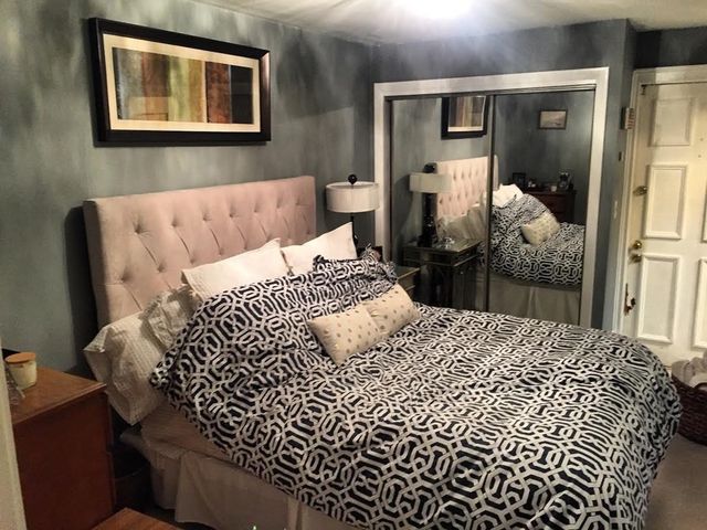 a bedroom with a bed and walk in closet