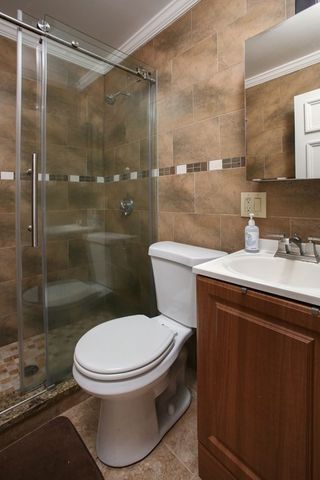 a white toilet sitting next to a bathroom sink