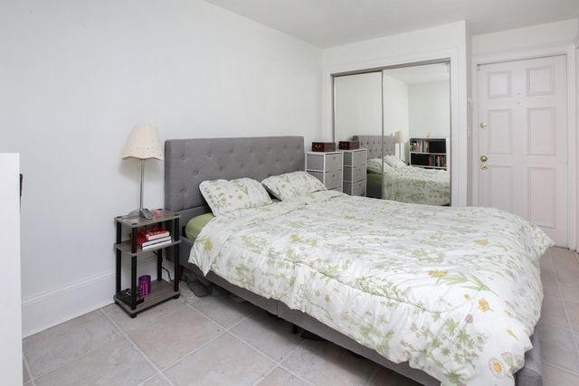 a bedroom with a bed and a cabinets