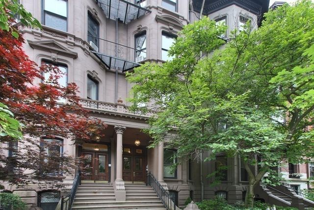 front view of a building with a tree