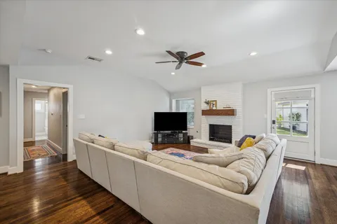 a living room with furniture a fireplace and a flat screen tv