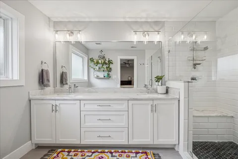 a bathroom with a shower sink and mirror