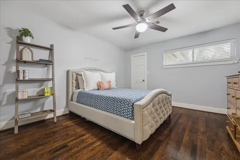 a bedroom with a bed chandelier and a window