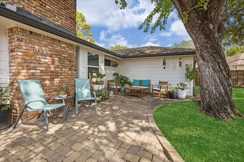 a backyard of a house with table and chairs